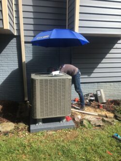 HVAC Contractor at work  in Frederick, MD - Dave's Cooling and Heating performing an AC repair 